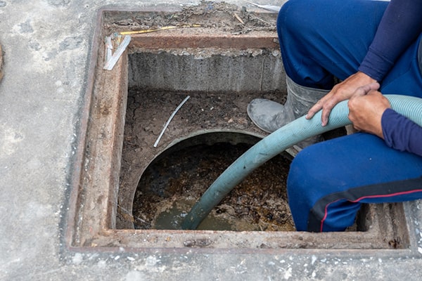 during grease trap pumping, a professional will pump out the accumulated grease and waste from the trap to prevent blockages and odors